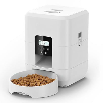 White pet food dispenser with a bowl of kibble on a white background